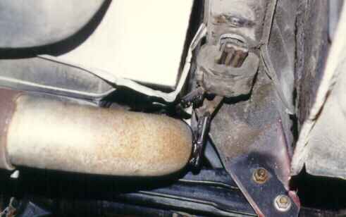 Use of the stock heat shield protecting the gas tank from the muffler